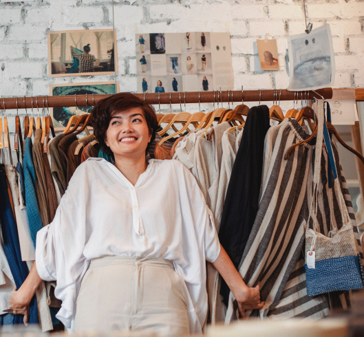 Happy woman because personalization pays off in her fashion store!